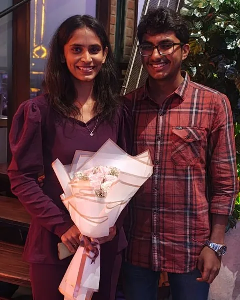 Anarghya holding a bouquet next to Ruthuparna at Pump House