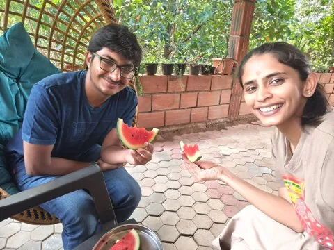 Both holding up slices of watermelon on their first visit to Unnenahalli